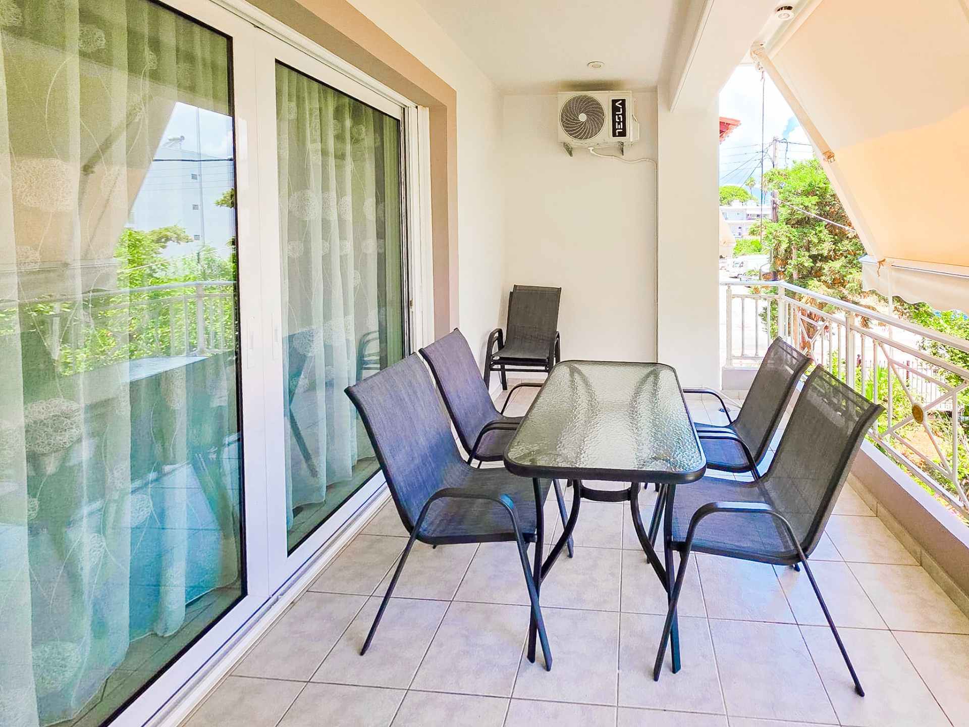 Covered terrace with outdoor seating and dining table