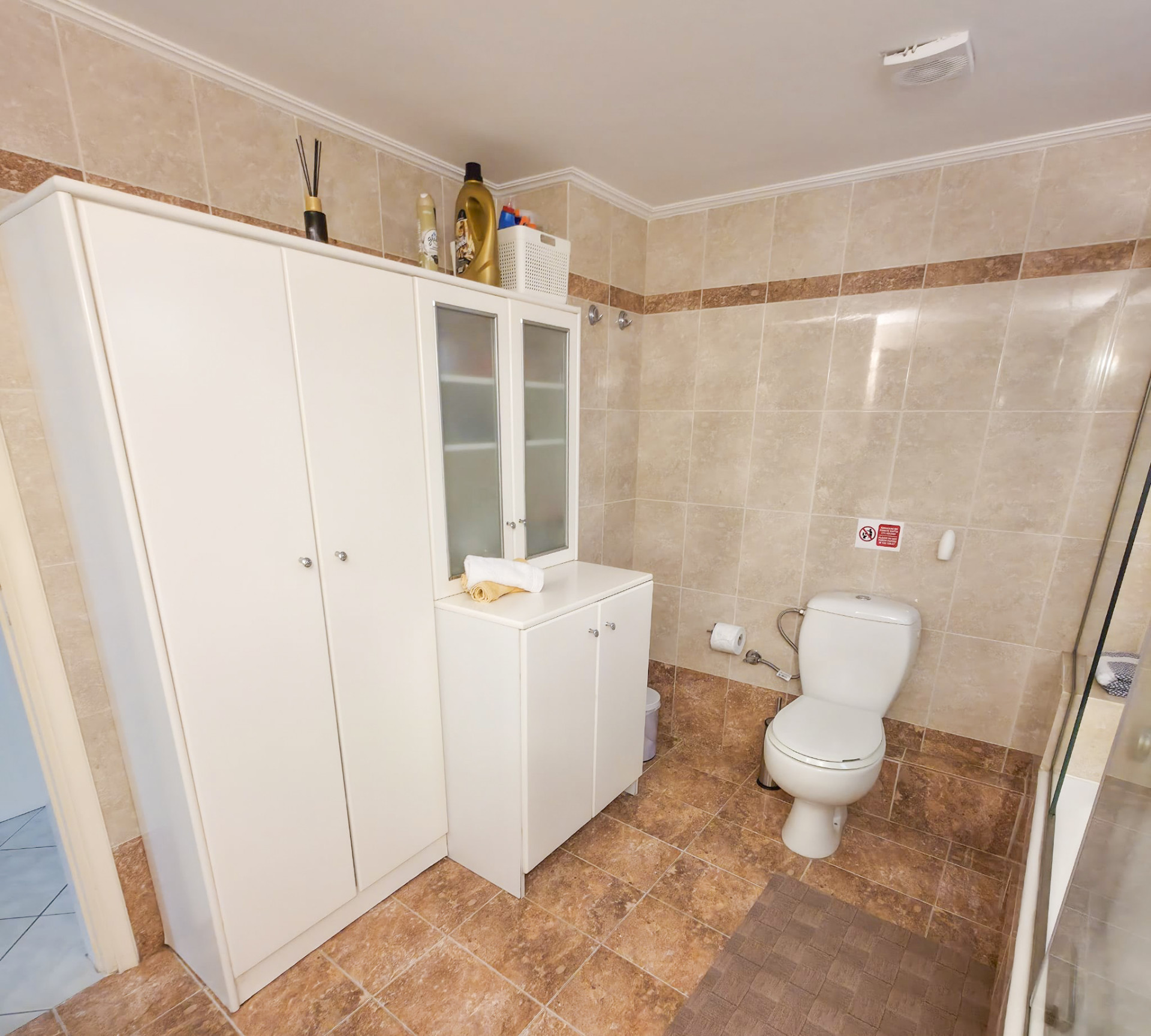 Main bathroom — storage and shower area