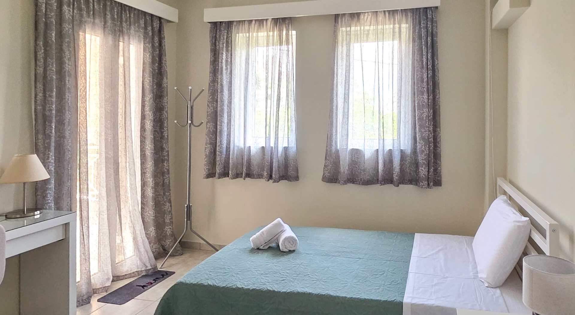Third bedroom showing windows and bed