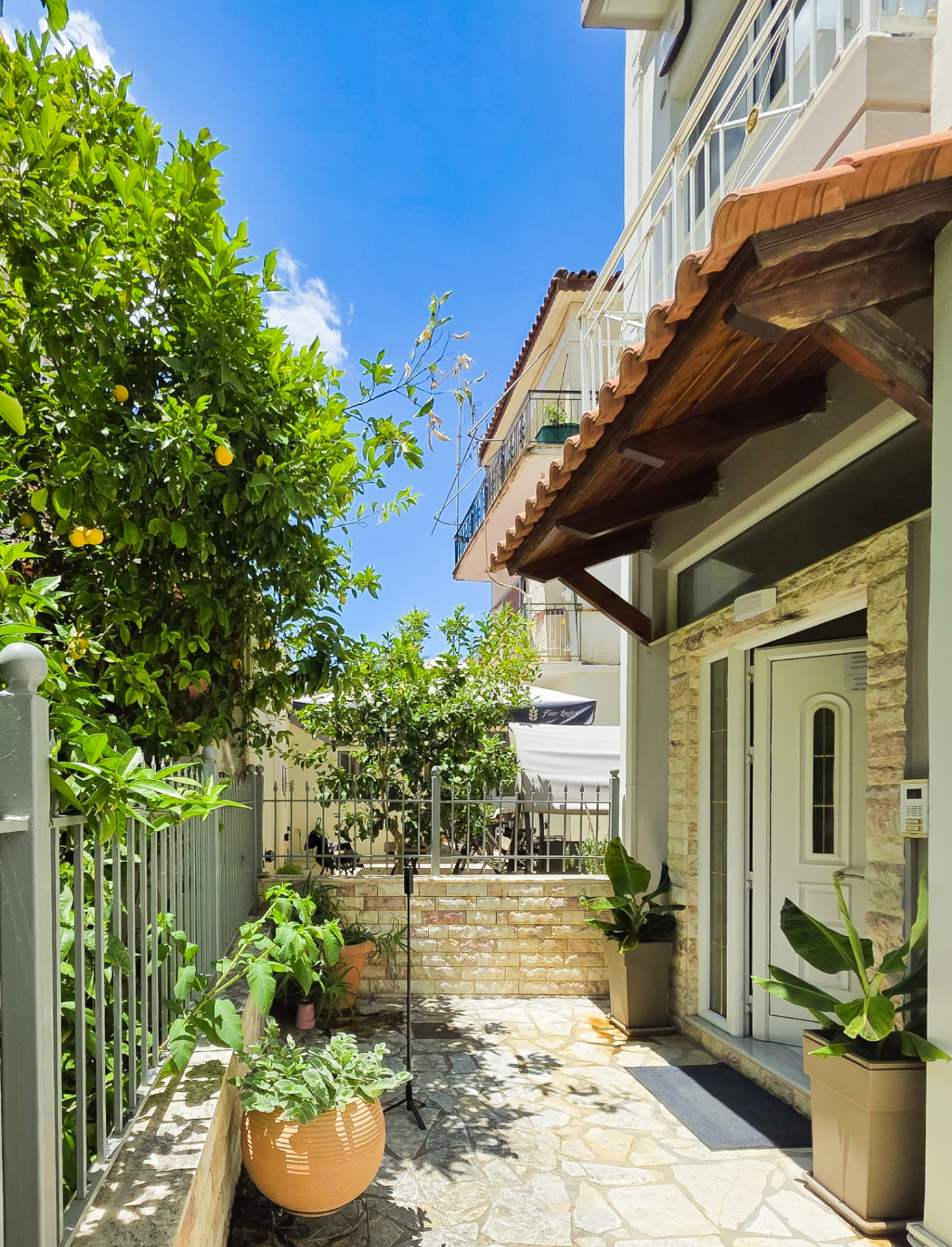 Private entrance with lemon trees and tiled patio