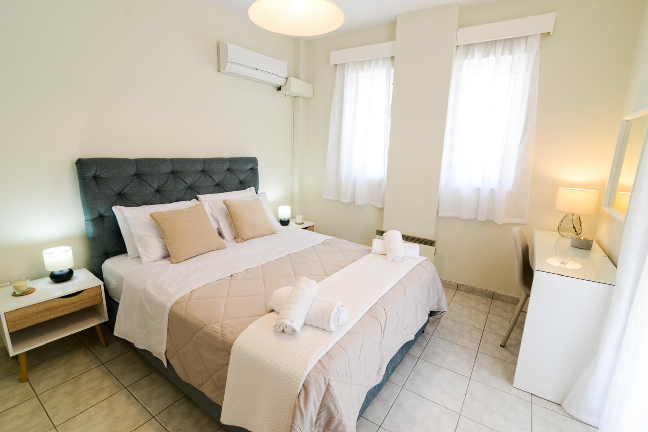 Third bedroom with queen bed and tufted headboard