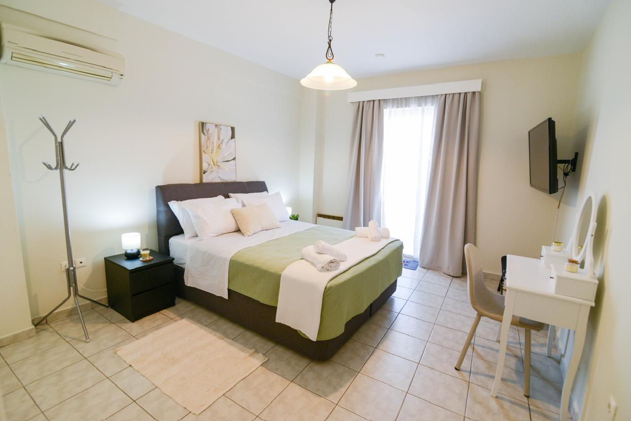 Master bedroom with TV and queen bed